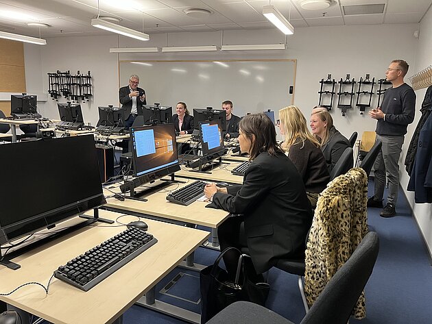 people in front of computers in a classroom