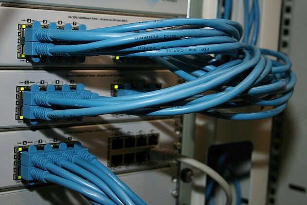 blue cords at the back of a server station